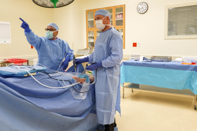 Dr Schumacher with a mustache standing in front of a building